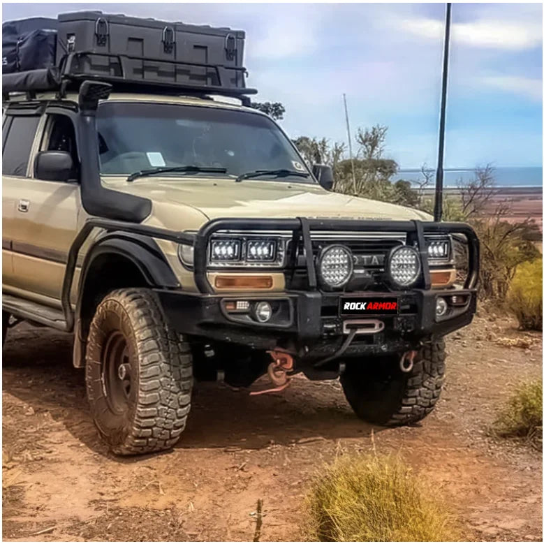 Load image into Gallery viewer, Off-road Toyota Land Cruiser with Rockarmor Brush Bars and Rockslider enhancement

