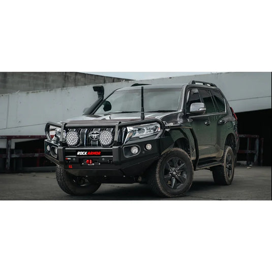 Black off-road SUV with Rockarmor Brushbar and Rockarmor Rockslider in premium steel