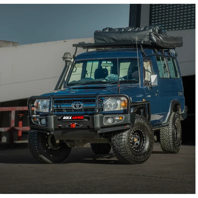 Load image into Gallery viewer, Blue off-road vehicle with roof tent featuring Rockarmor Brushbar and premium steel design
