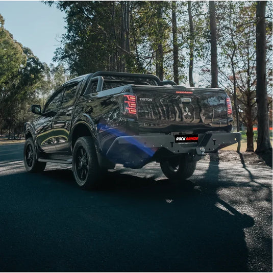 Black Mitsubishi Triton pickup truck with Rockarmor Elite Steel Rear Step Tow Bar
