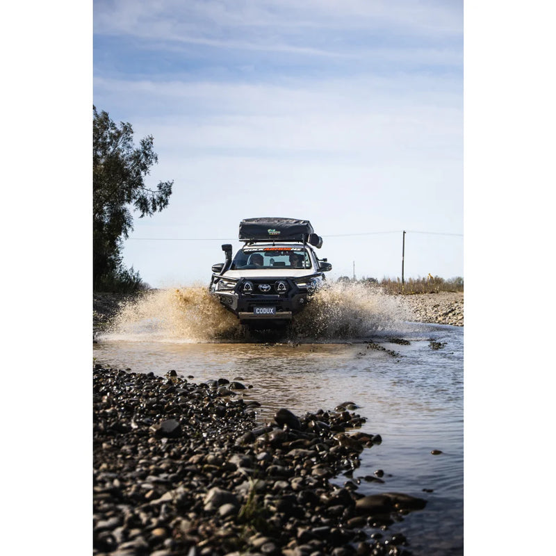 Load image into Gallery viewer, White off-road truck with steel hoop bull bar and driving lights navigating water
