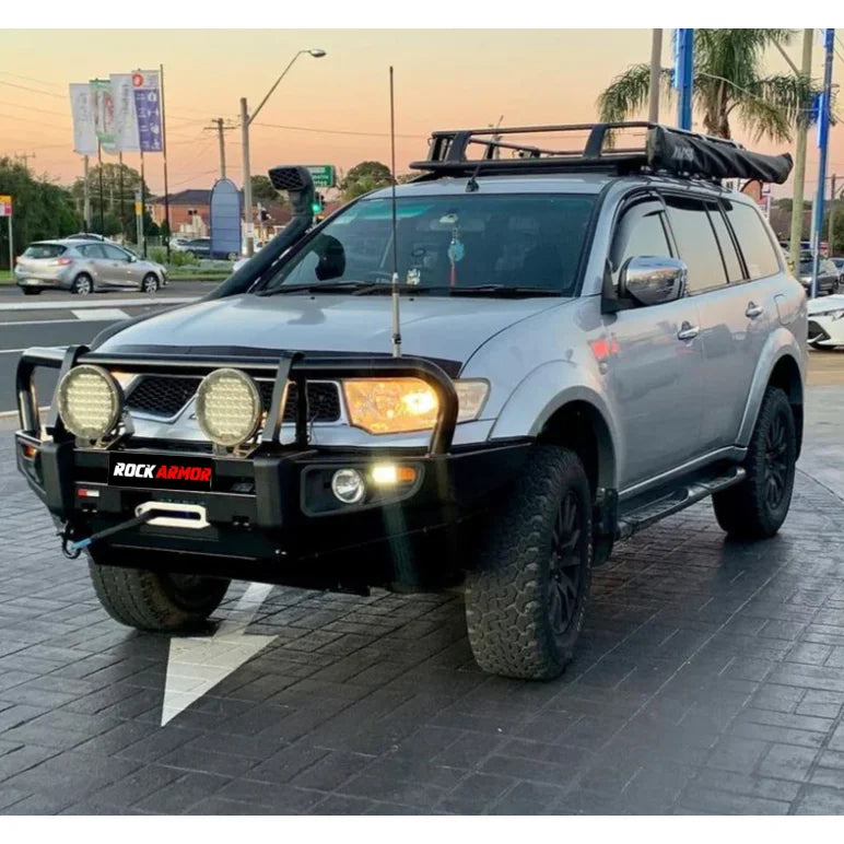 Load image into Gallery viewer, Silver SUV with off-road modifications featuring Rockarmor steel bullbar and fog lights
