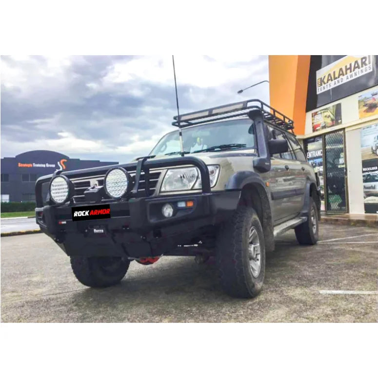 Load image into Gallery viewer, Modified off-road vehicle featuring Rockarmor premium steel bullbar with fog lights installation
