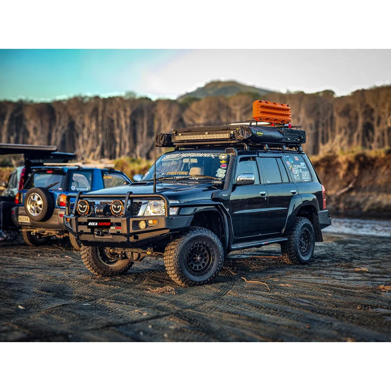 Load image into Gallery viewer, Black off-road vehicle featuring a premium steel bullbar with fog lights for Nissan Patrol GU4
