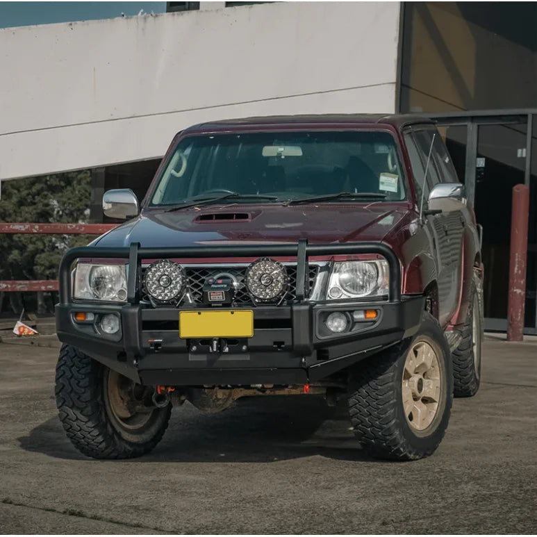 Load image into Gallery viewer, Maroon Nissan Patrol GU4 with premium steel bull bar and fog lights for off-road use
