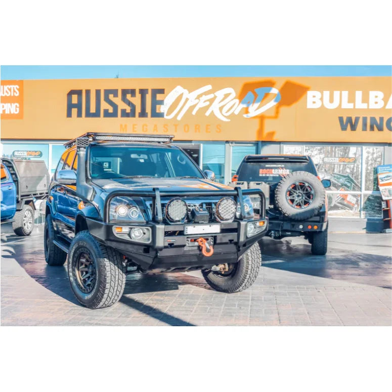 Load image into Gallery viewer, Modified off-road vehicle with Rockarmor premium steel bull bar and fog lights installed
