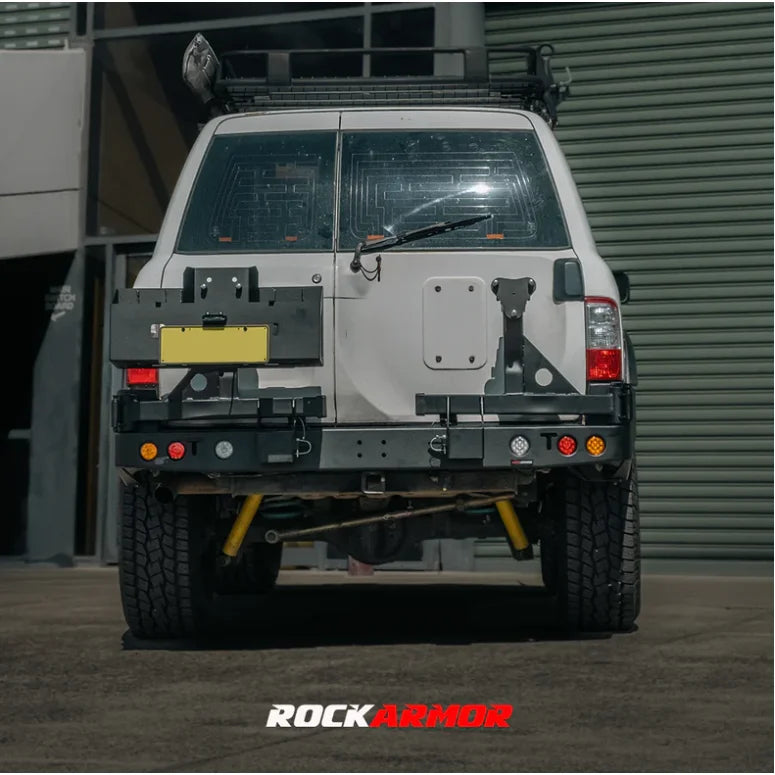 Load image into Gallery viewer, White SUV rear view with Rockarmor Steel Dual Wheel Carrier for Nissan Patrol Y61

