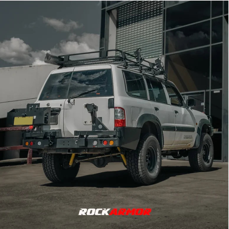 Load image into Gallery viewer, White off-road vehicle with roof rack featuring Rockarmor steel dual wheel carrier for Nissan Patrol Y61 with spare wheel, fitting video available
