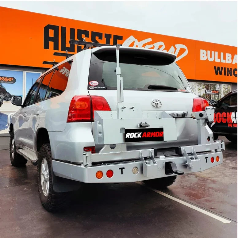 Load image into Gallery viewer, Silver SUV with aftermarket rear bar and wheel carrier for spare wheel on Toyota Landcruiser
