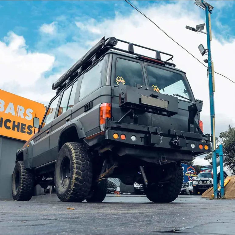 Load image into Gallery viewer, Modified black off-road vehicle with Rockarmor dual wheel carrier for Toyota Landcruiser FJ75 FJ76 FJ78
