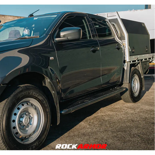 Black pickup truck with tray featuring Rockarmor Steel Rock Sliders for Isuzu Dmax 08/20+