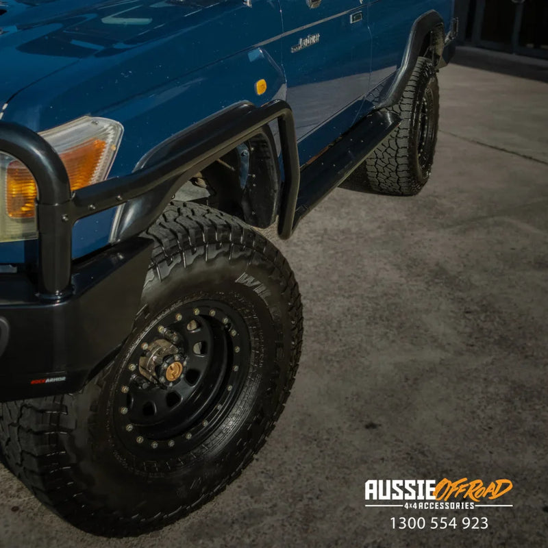 Load image into Gallery viewer, Blue off-road vehicle with steel checker plate bull bar and black wheels on Toyota Landcruiser
