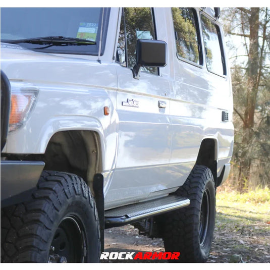White off-road vehicle with steel checker plate Rockslider side steps on Toyota Landcruiser