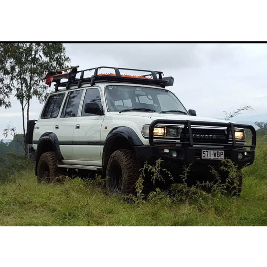 White Toyota Land Cruiser with roof rack and steel checker plate Rockslider side steps